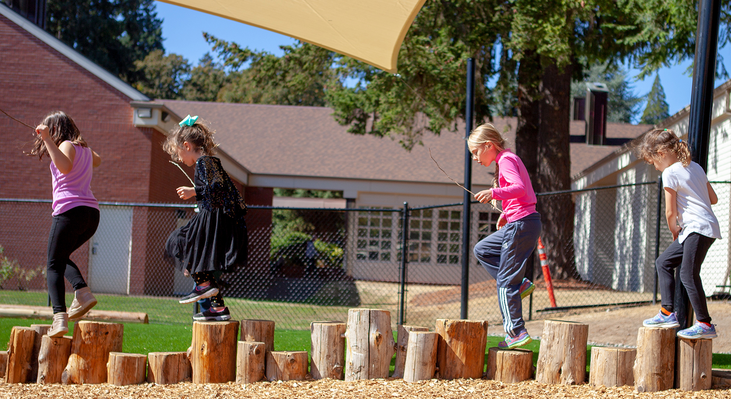 ELC students practice their balance in the Brim Family Outdoor Learning Center.