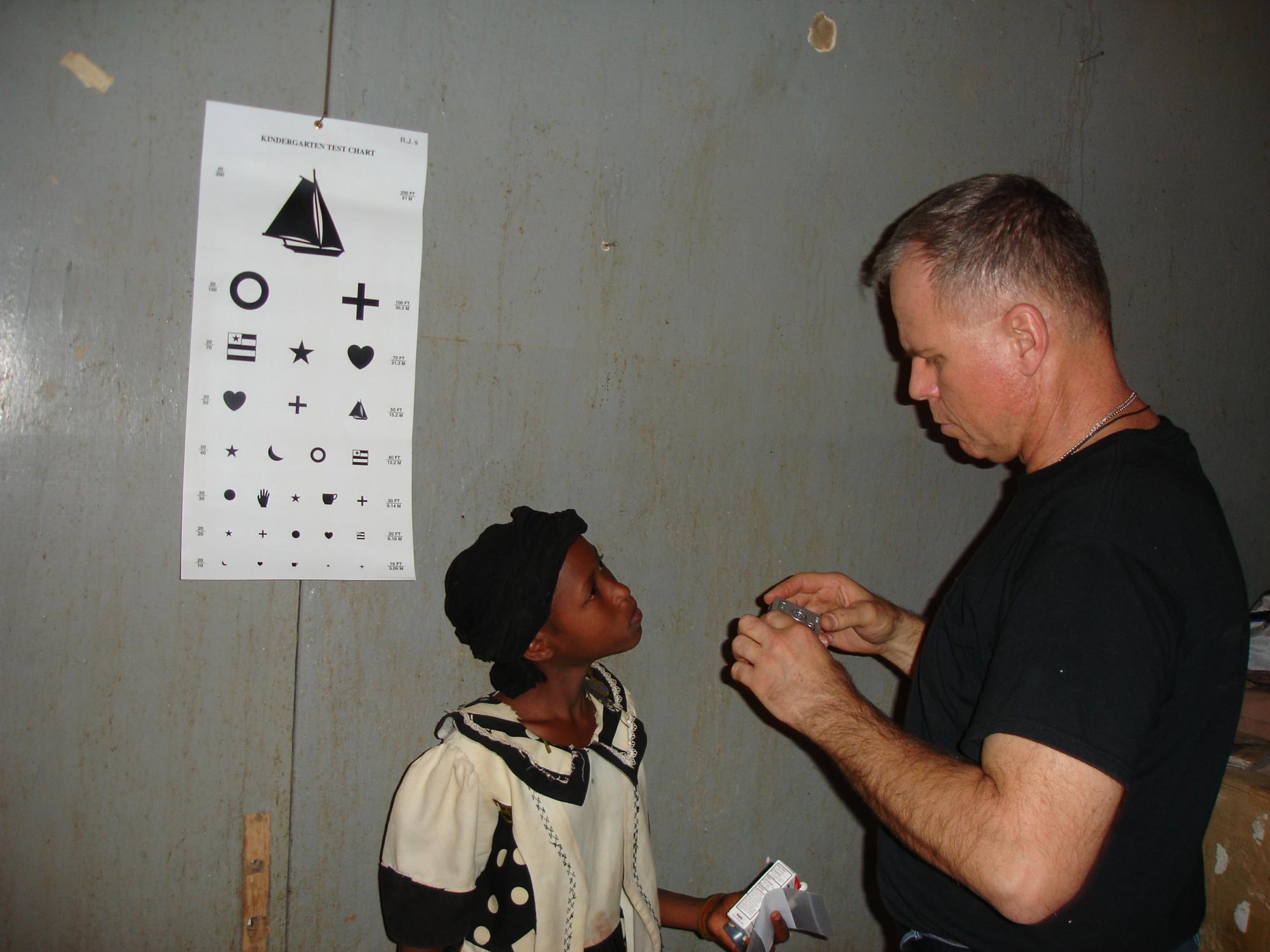 Boeck prepares to try a lens on a girl in Niger, where he was deployed