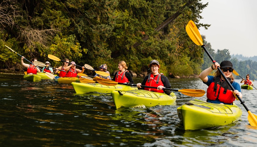 A Line Of Kayaks On The Willamette River During An Adventures Without Limits Trips