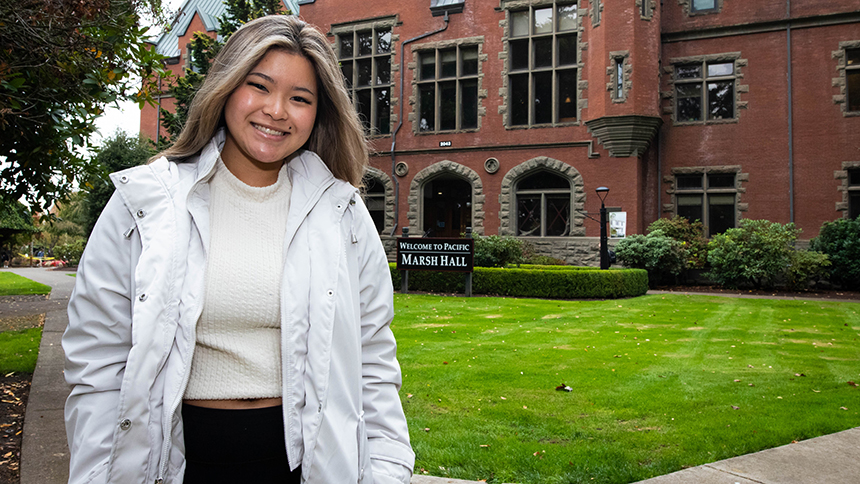 Annie Ho poses in front of Pacific University's Marsh Hall