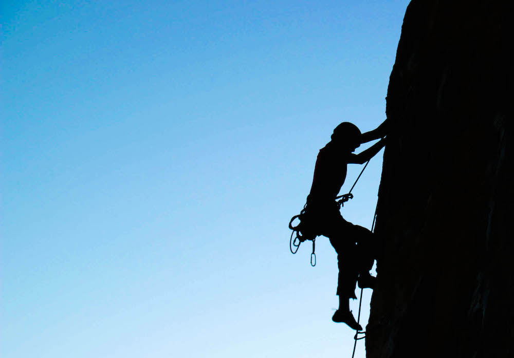 rock climber silhouette on mountain