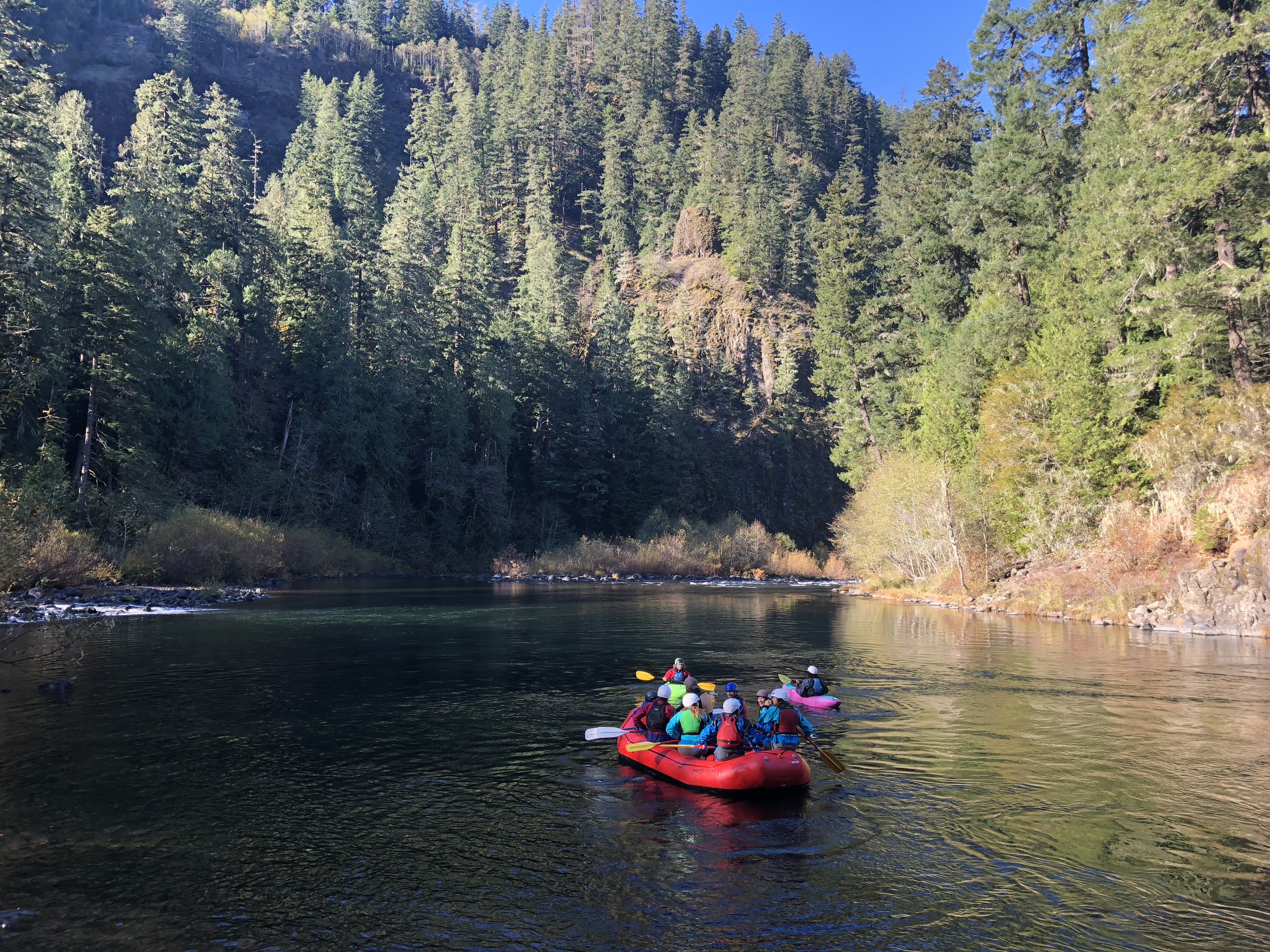 Students with Pacific's Outdoor Pursuits program raft down a river