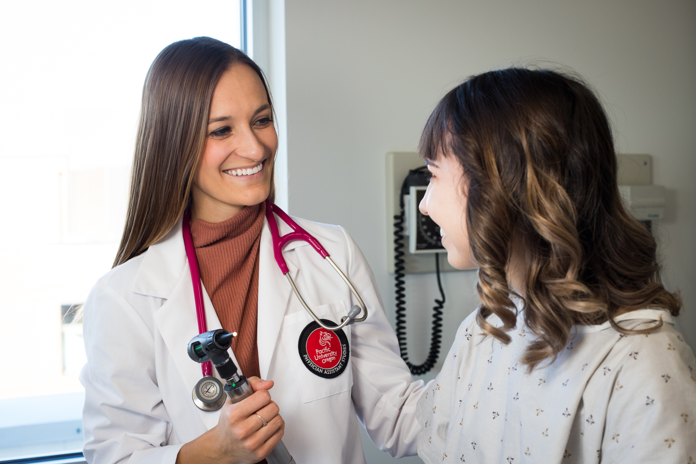 A physician assistant student consults with a patient.