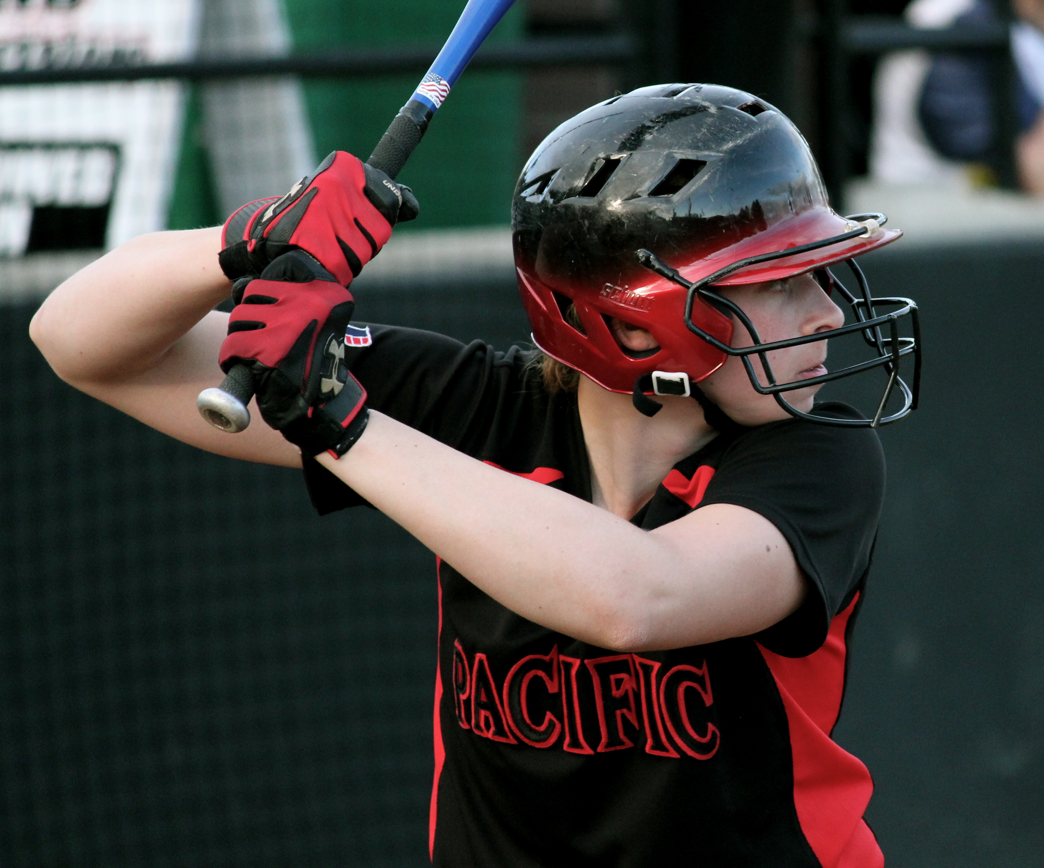 A Pacific softball player stands at the plate prepared to receive a pitch.