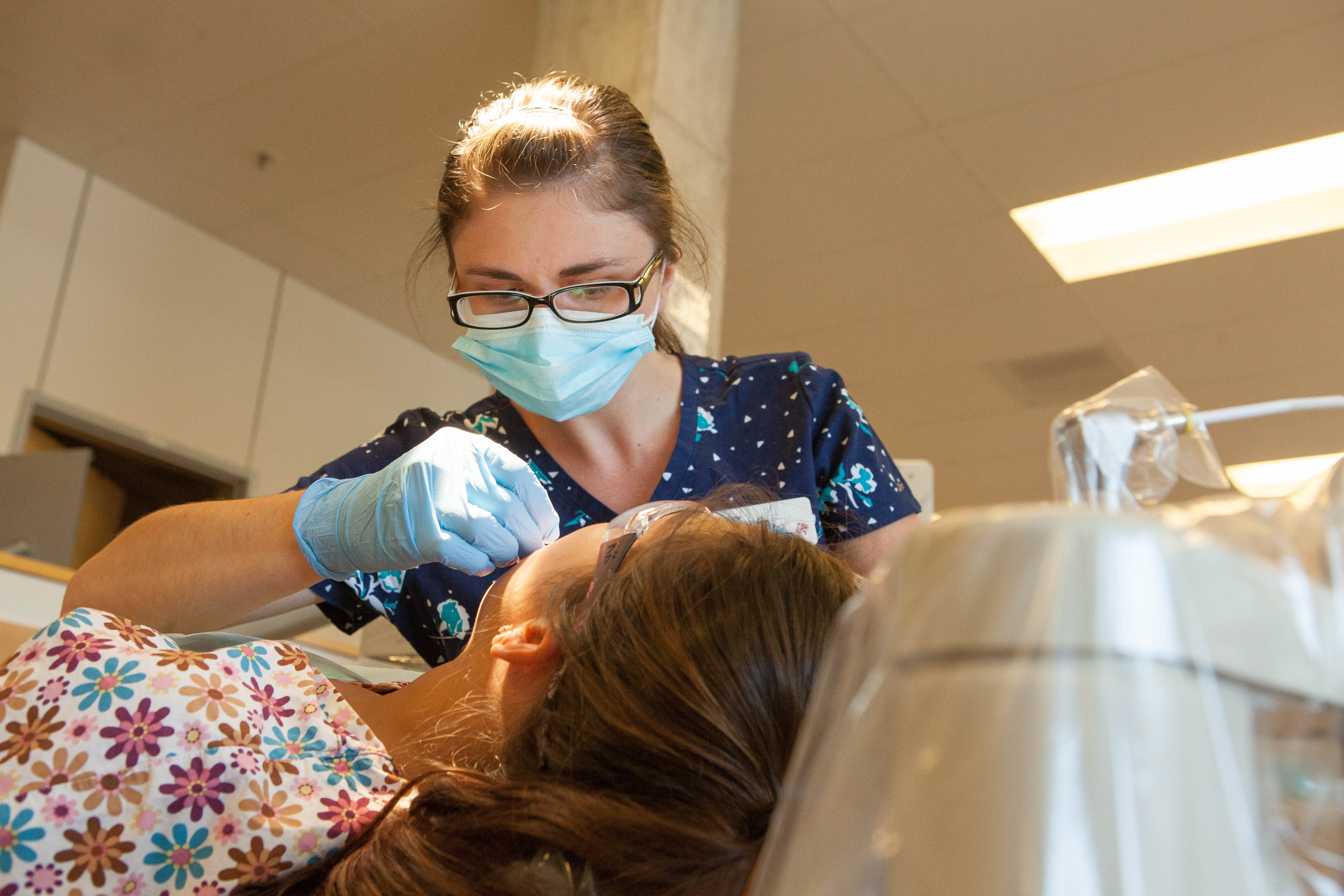 A dental hygiene students works on a patient at Pacific's Dental Hygiene Clinic.