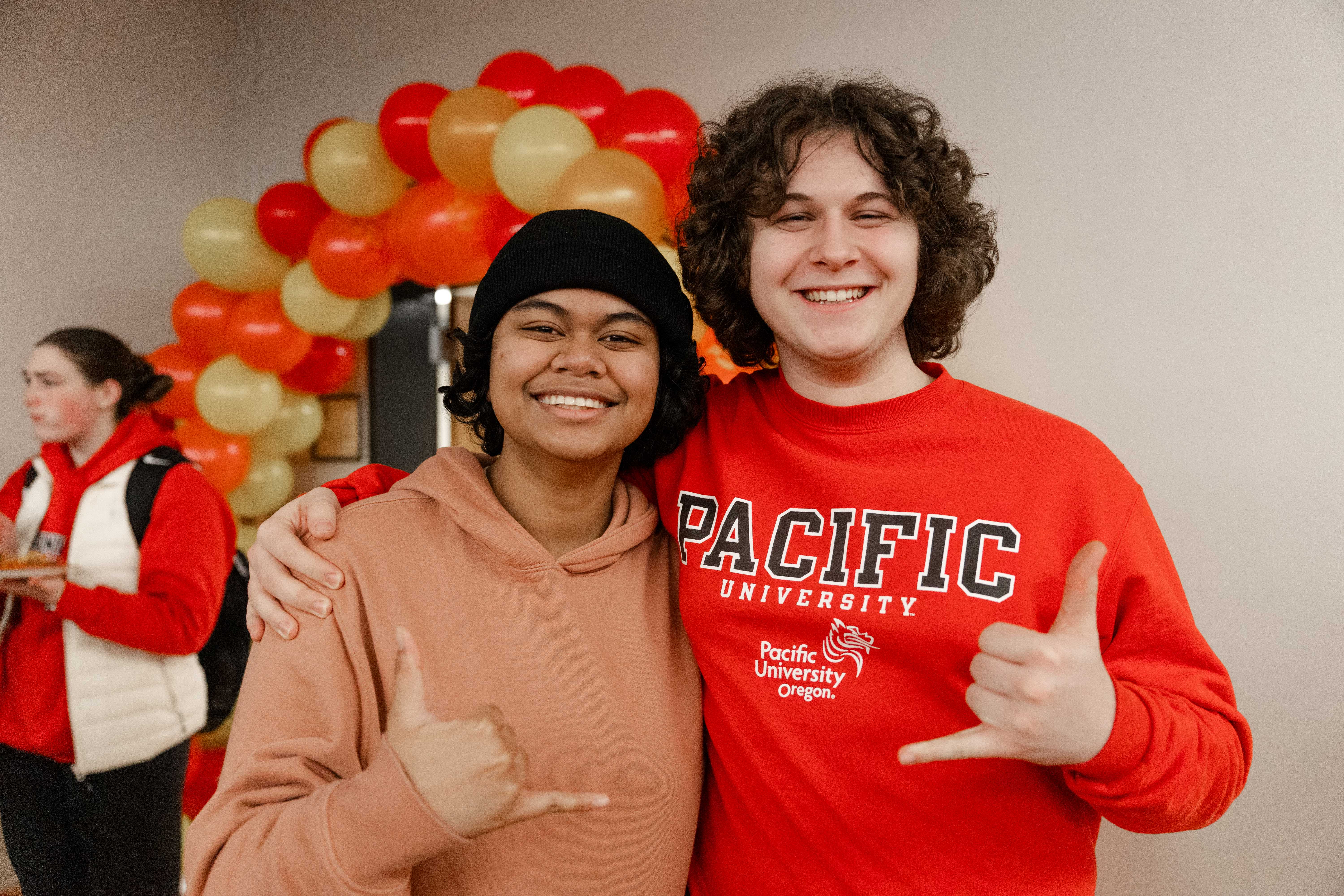 Two students pose for a photo during a Lunar New Year celebration.