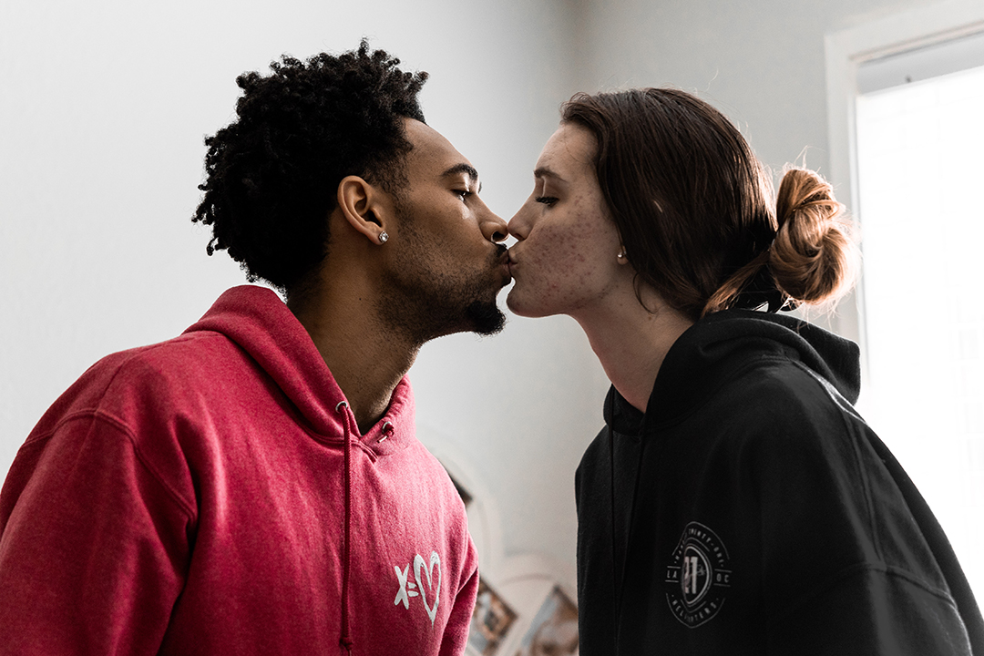 Devin Fortune '25 and his wife, Kristina, share a quick kiss