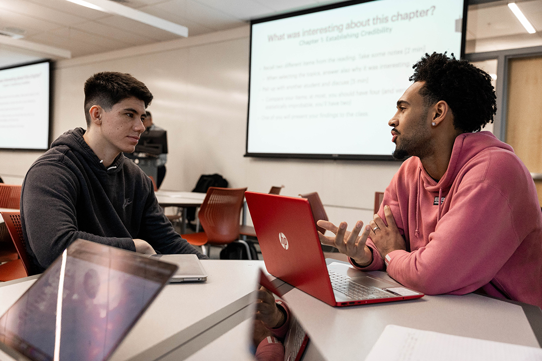 Devin Fortune '25, right, and Zach XXX discuss business law during class at Pacific University