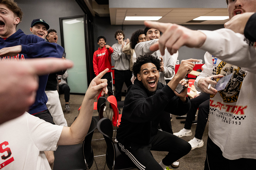 Members of the Boxer men's basketball team play a team-building game with Devin Fortune '25 pictured at center