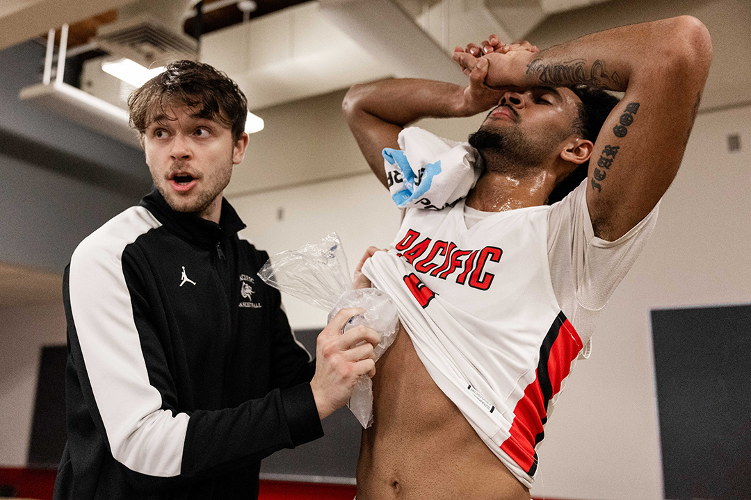 Jacob Bolger '24 gets Devin ice after he was injured in a basketball game