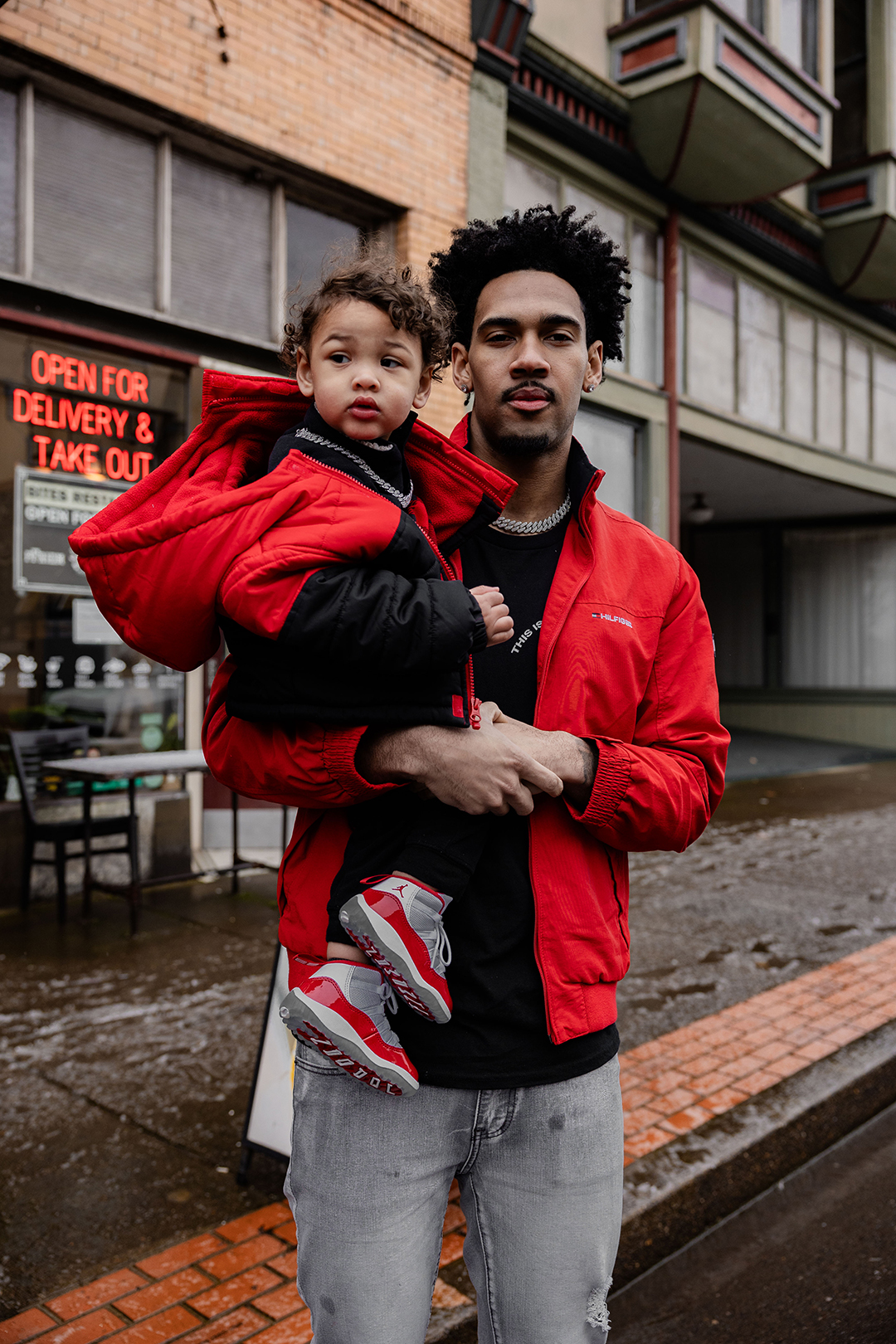 Devin holding his son, Rocket, in downtown Forest Grove