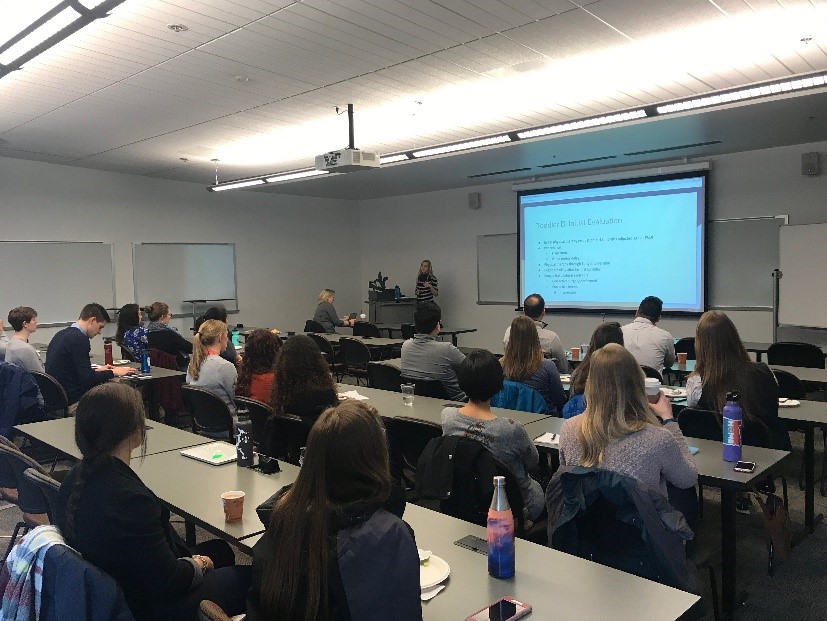   Justin Lee, SPT from George Fox University; Jaylen Wilson, SPT (‘2020); Chalo Saldivar, SPTA from Mt. Hood Community College; and Ellen Key (‘2020).      Picture at the front and left side of the room is Dr. Lydia Jahn (‘2018) during her presentation