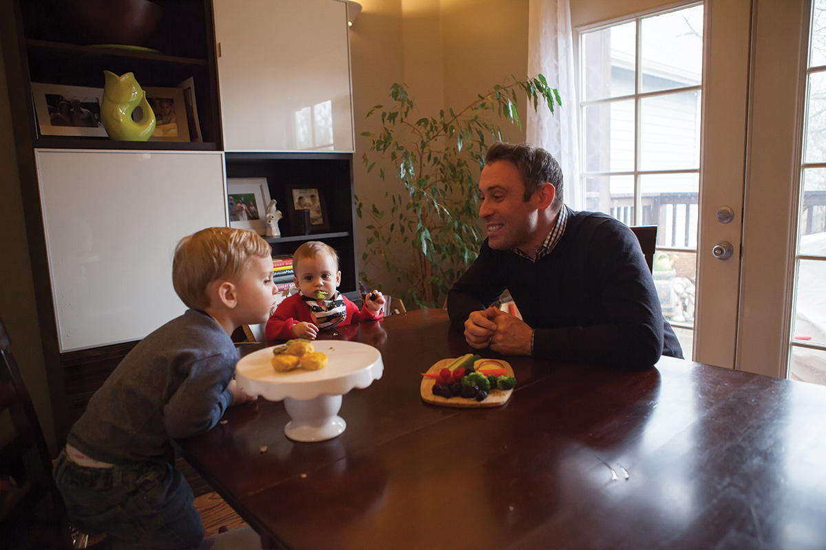 Dustin pictured with younger children eating the snacks. 