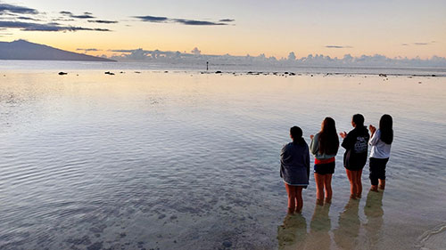 Students Standing And Looking At The Ocean