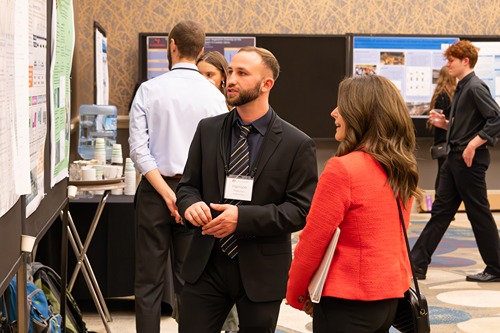 Harrison Freeman Explains Poster Presention To Pacific President Jenny Coyle