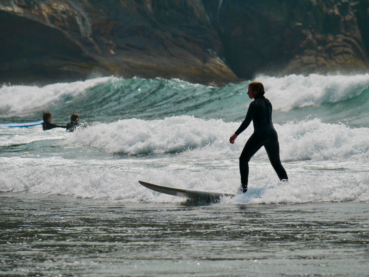A woman surfs at the Oregon coast