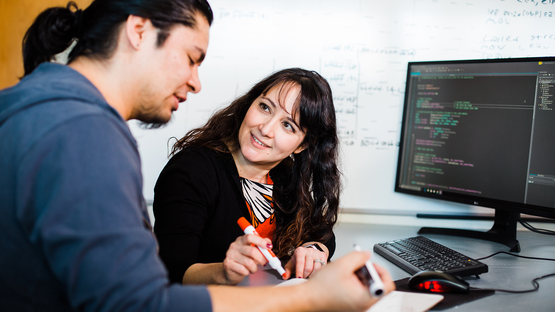 A computer science professor instructs a student through a coding problem