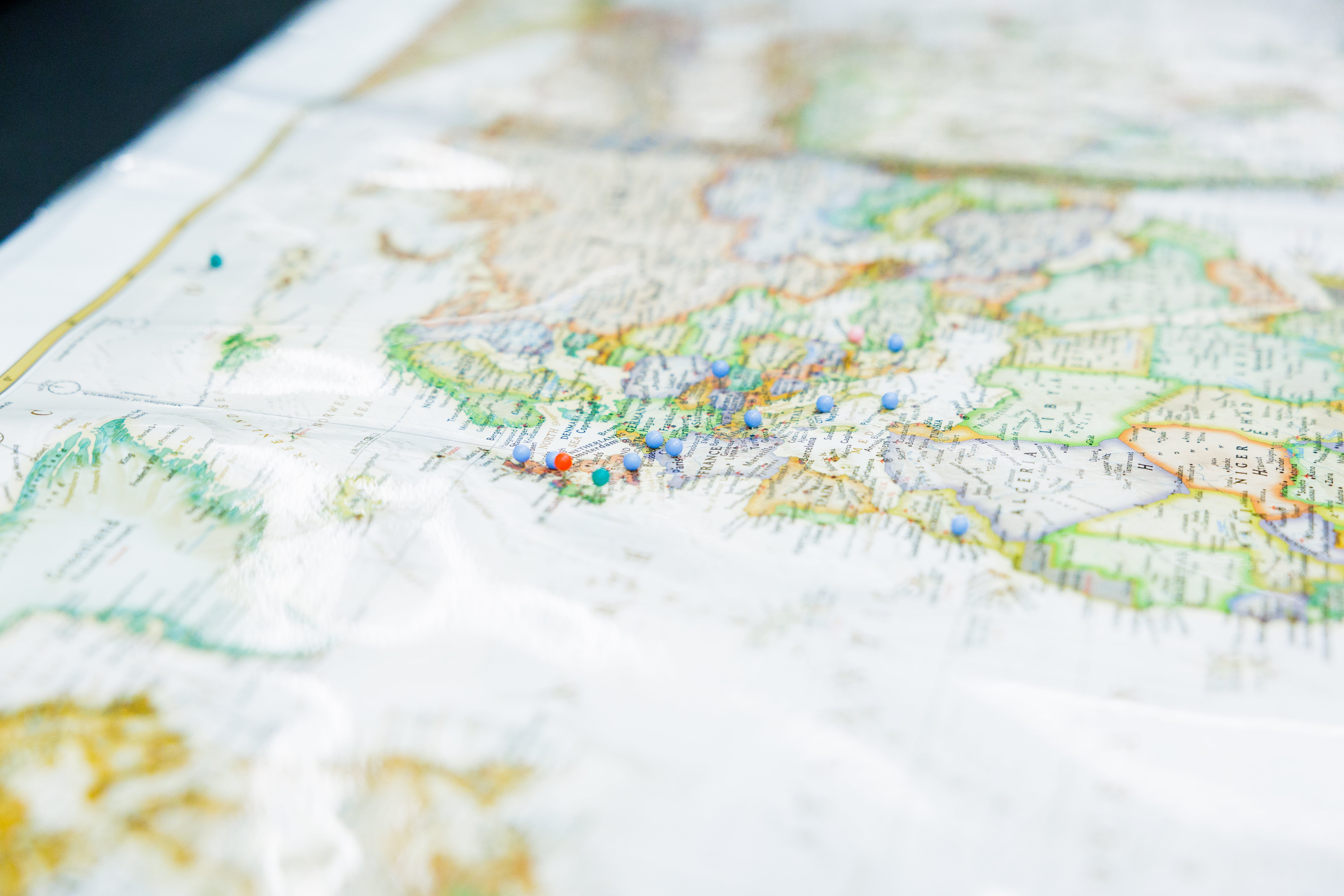 A paper world map sits atop a table.