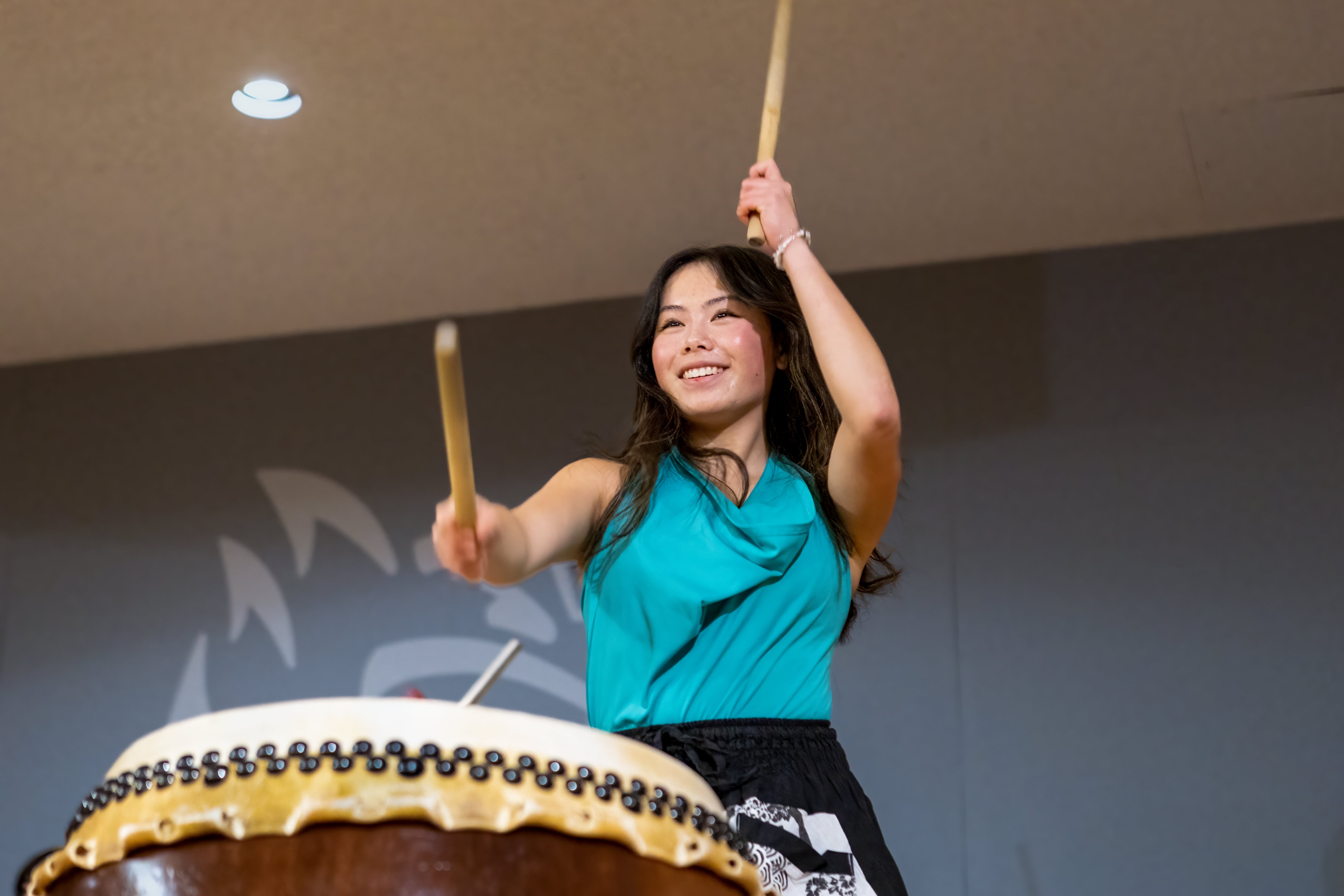 A student plays Taiko at the Pacific Lunar New Year ceremony.