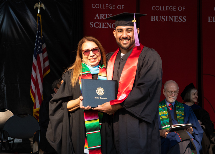 Javier Barron receives award at August commencement