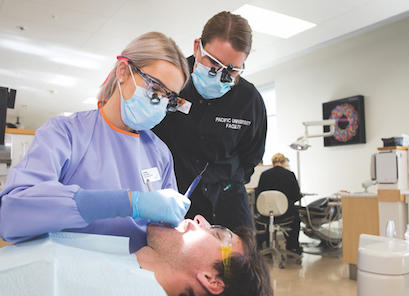 dental students working on a patient