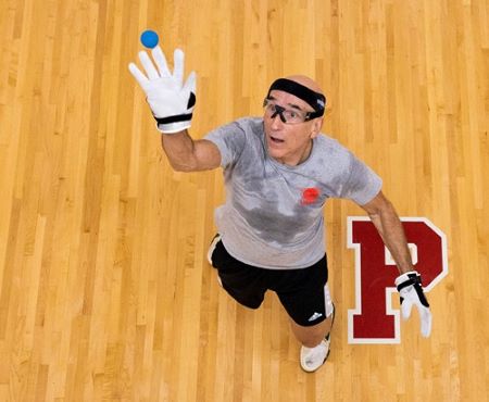 Man wearing glasses, running in Pacific University gym