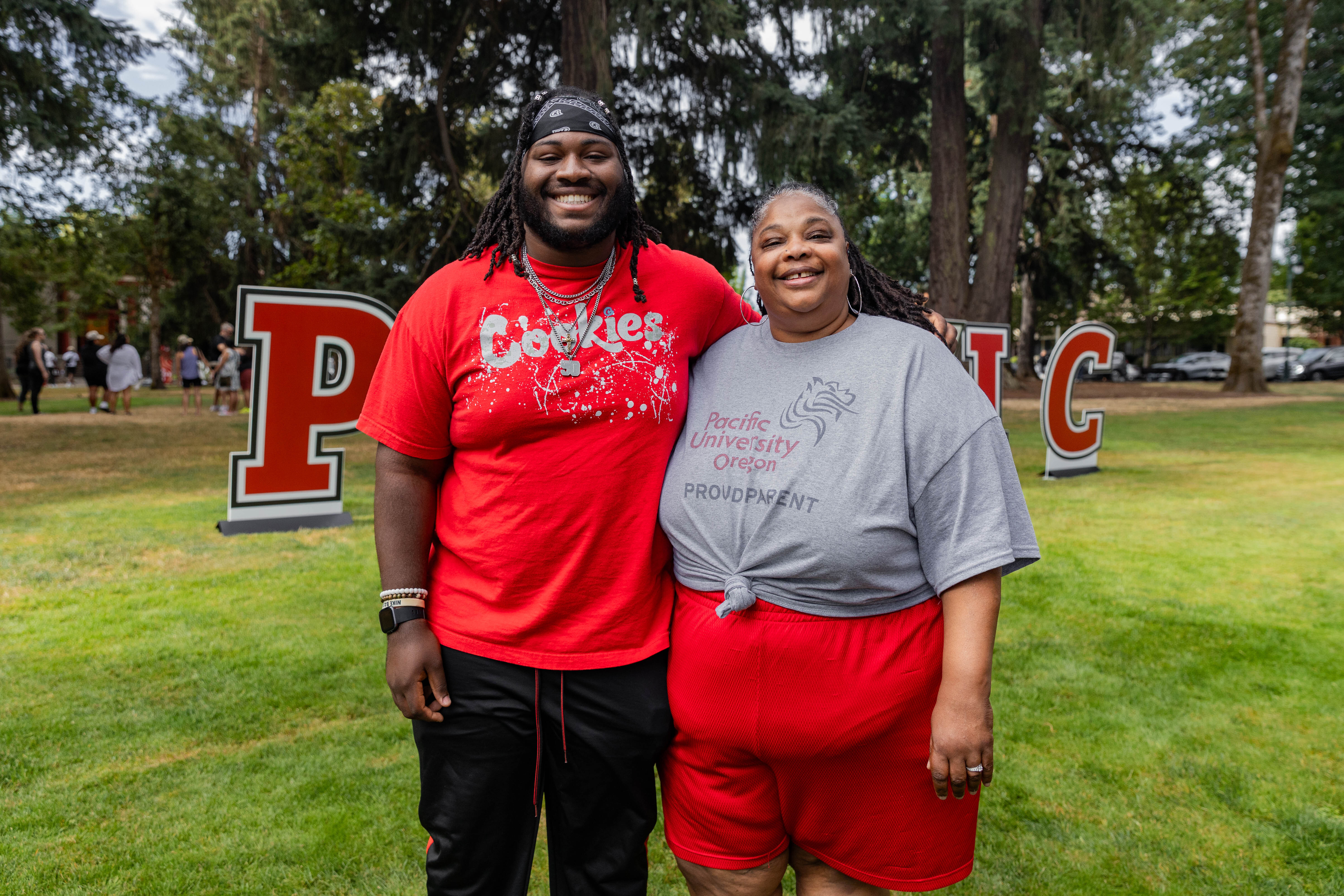 A parent poses with their adult child during move-in day at Pacific's Forest Grove campus.