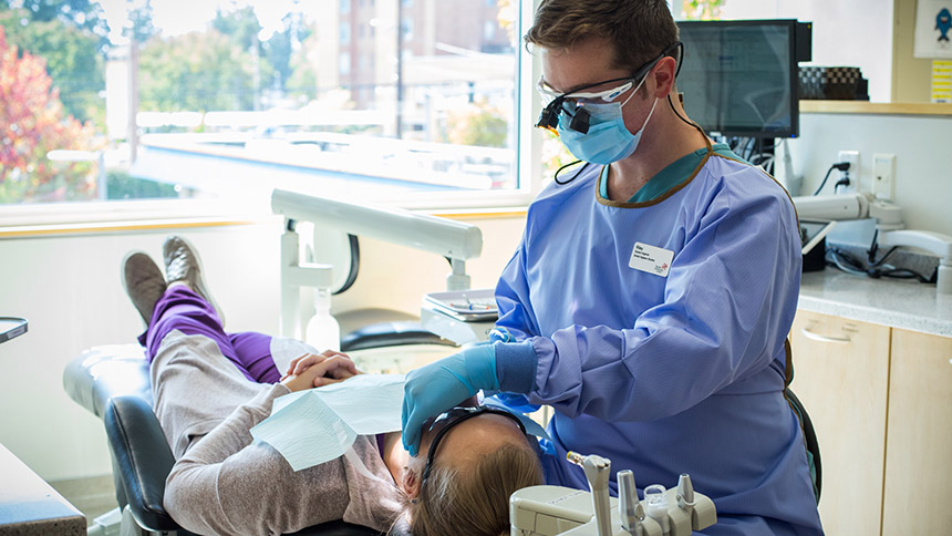 A Pacific University dental hygiene student treats a patient in the clinic