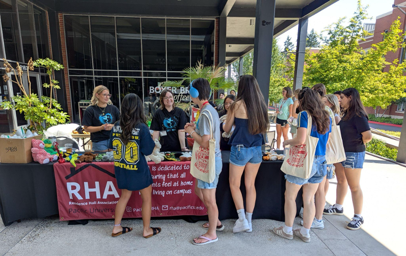 Pacific University students visit an RHA table on campus