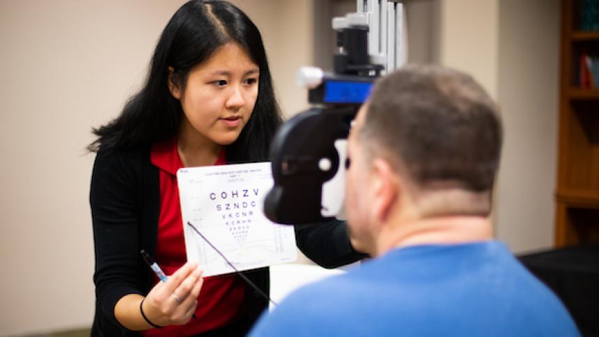 Student conducting an eye exam