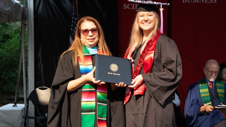 Simonne Lighthouse receives award at August commencement