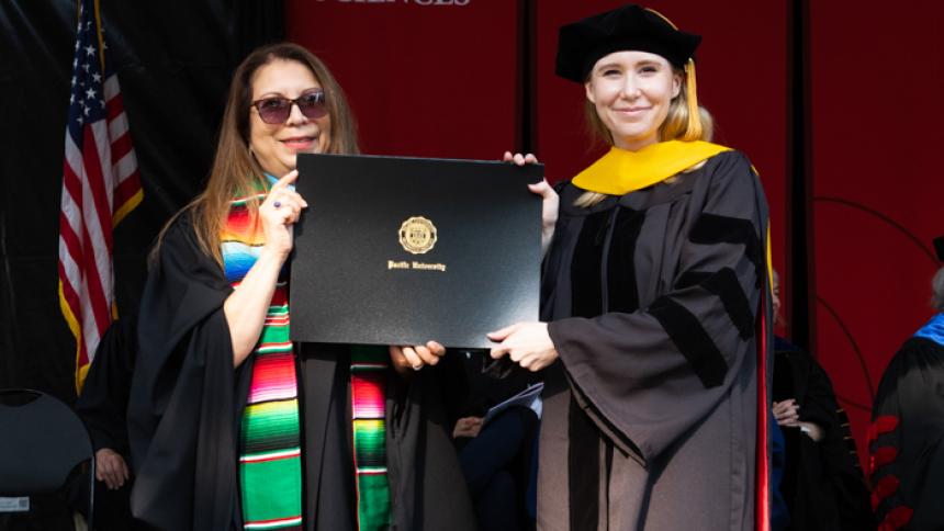 Æx Barr receives award at August commencement