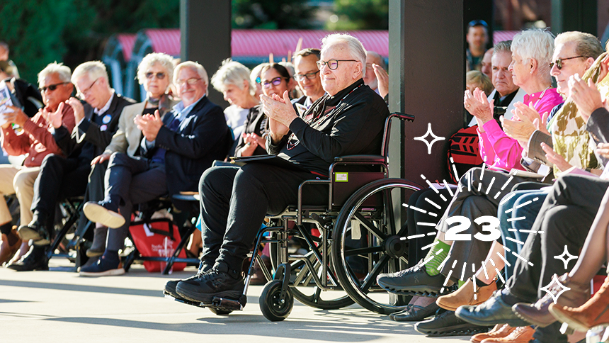 Les AuCoin '69, center, sits among guests at the dedication of Les AuCoin Hall