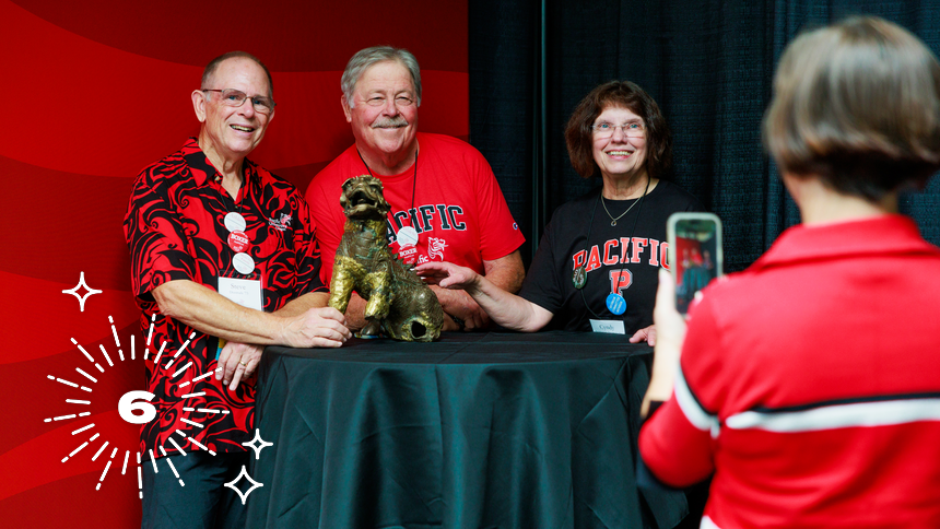 Alumni pose with Boxer I during Homecoming