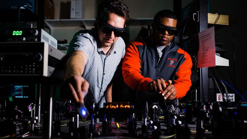 Professor Andy Dawes & Kevin McGee '18 in the laser lab at Pacific
