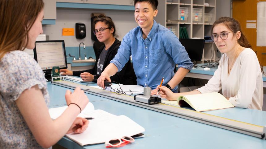 A group of undergraduate students discuss coursework in one of Pacific's engineering physics labs.