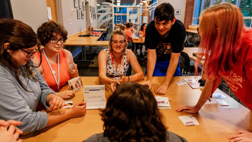 Students get to know one another over a card game during new student orientation.