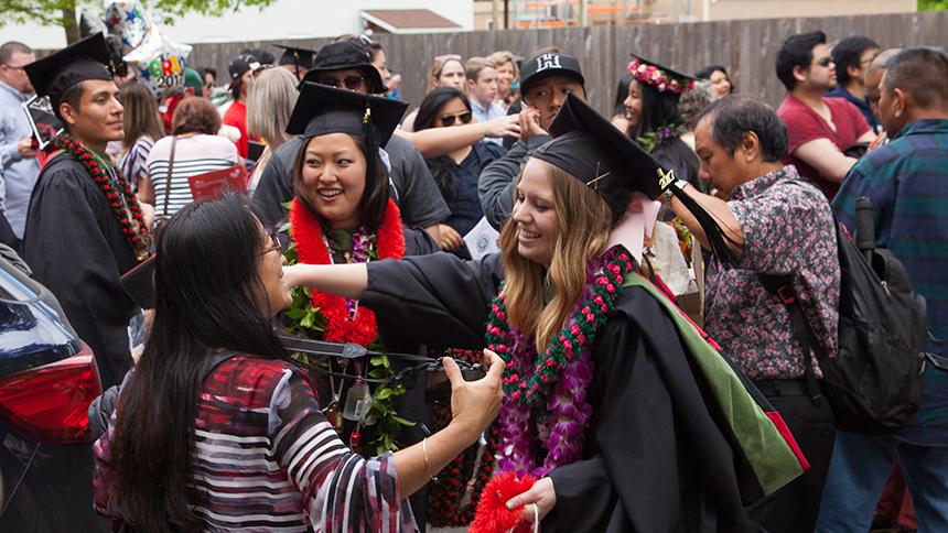 Graduates hug family and friends at Commencement