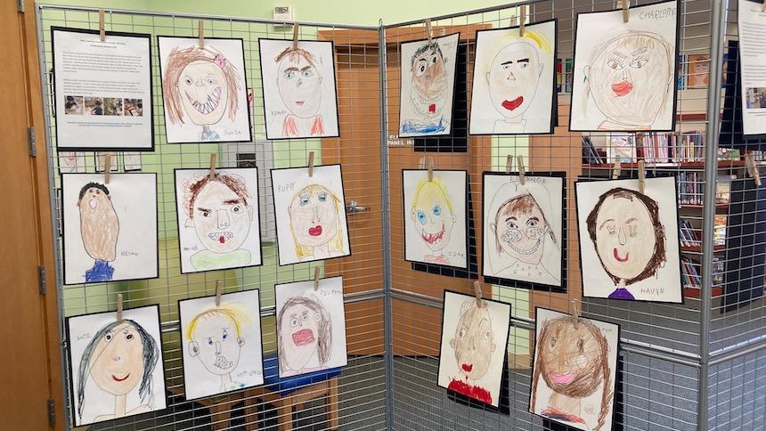 Kindergarten self-portraits hung up in the library. 