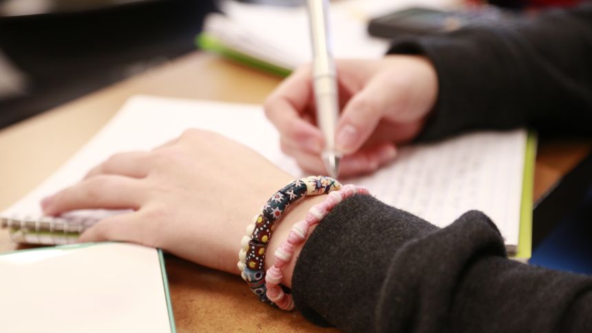 Person writing in notebook