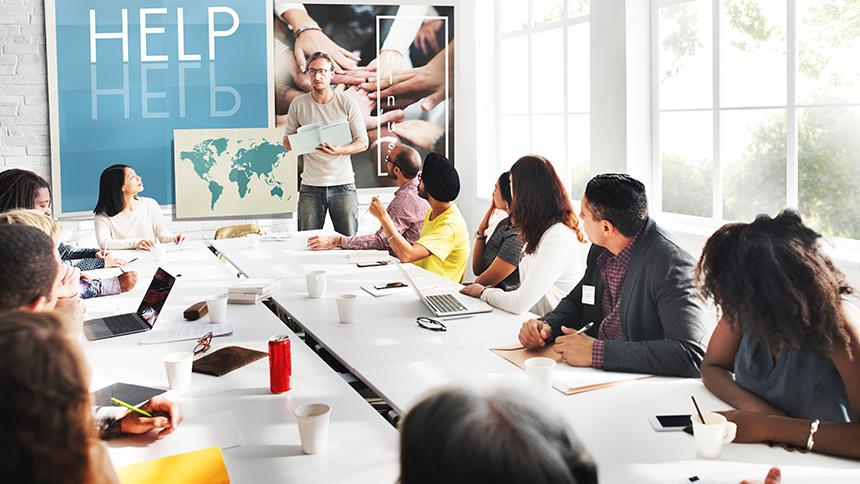 Stock photo of people around a large table in an office
