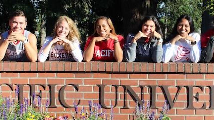 Students on entrance wall of Pacific University