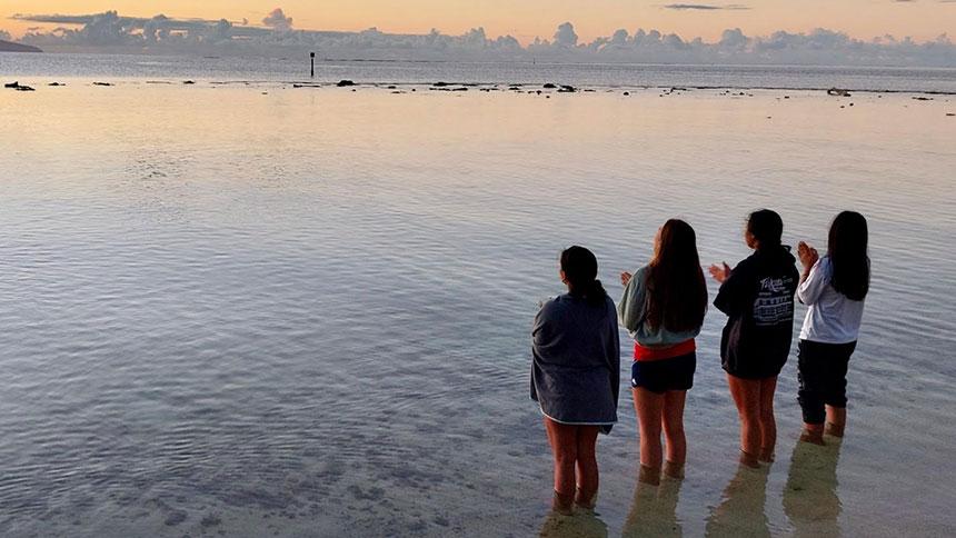 Students Standing And Looking At The Ocean