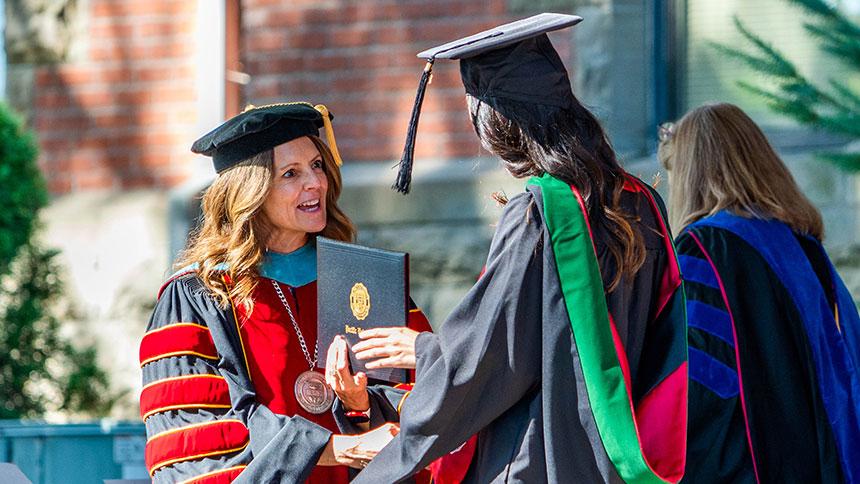 Dr. Jenny Coyle Congratulating A Graduate At Pacific's August 2023 Commencement Ceremony