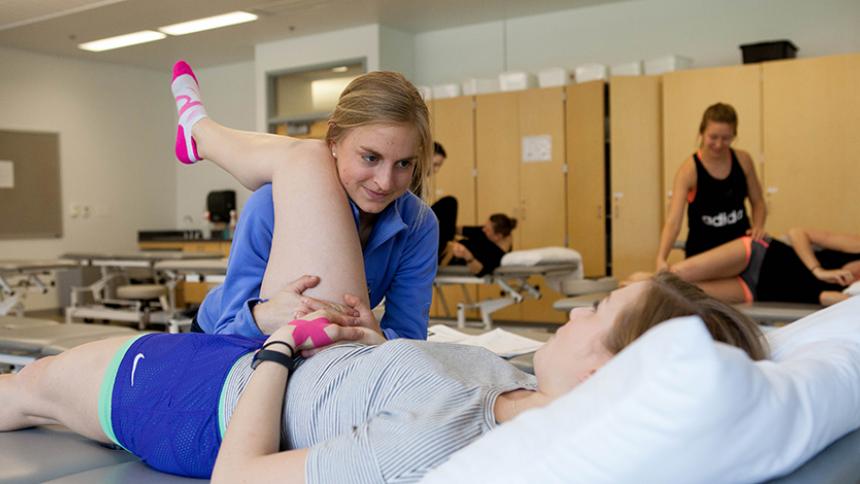 Student performing Physical Therapy work on a patient