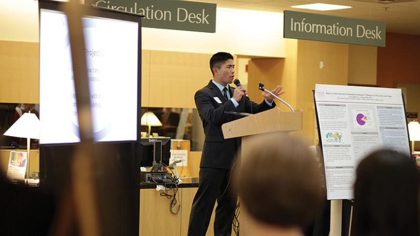 Tyler Oshiro '13 Giving a presentation
