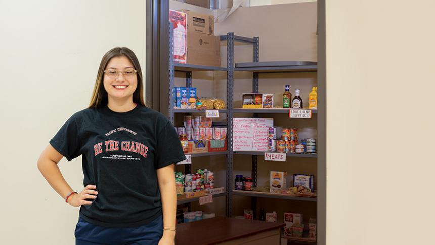 Ruth Gomez '19 in front of the Boxer Food Share