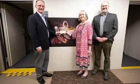 Matt Brink (left) of the Hillsboro Lions Club presents Pacific School of Audiology Director Wendy Hanks (center) and Assistant Professor of Audiology Marcin Wróblewski (right) with a check for the School of Audiology Legacy Scholarship