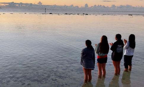 Students Standing And Looking At The Ocean