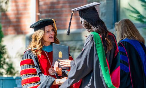 Dr. Jenny Coyle Congratulating A Graduate At Pacific's August 2023 Commencement Ceremony